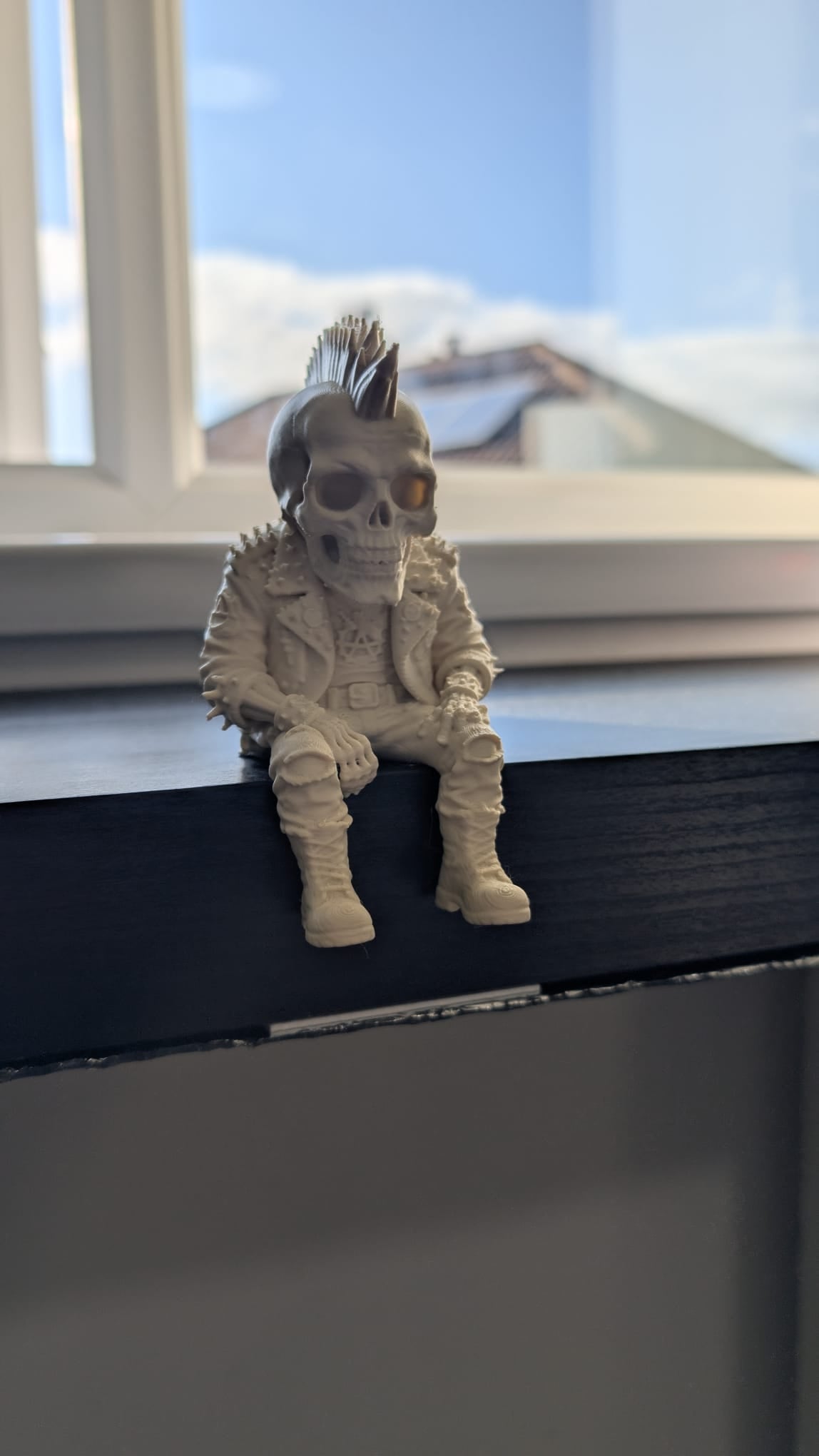 Punk biker skeleton figurine on a windowsill