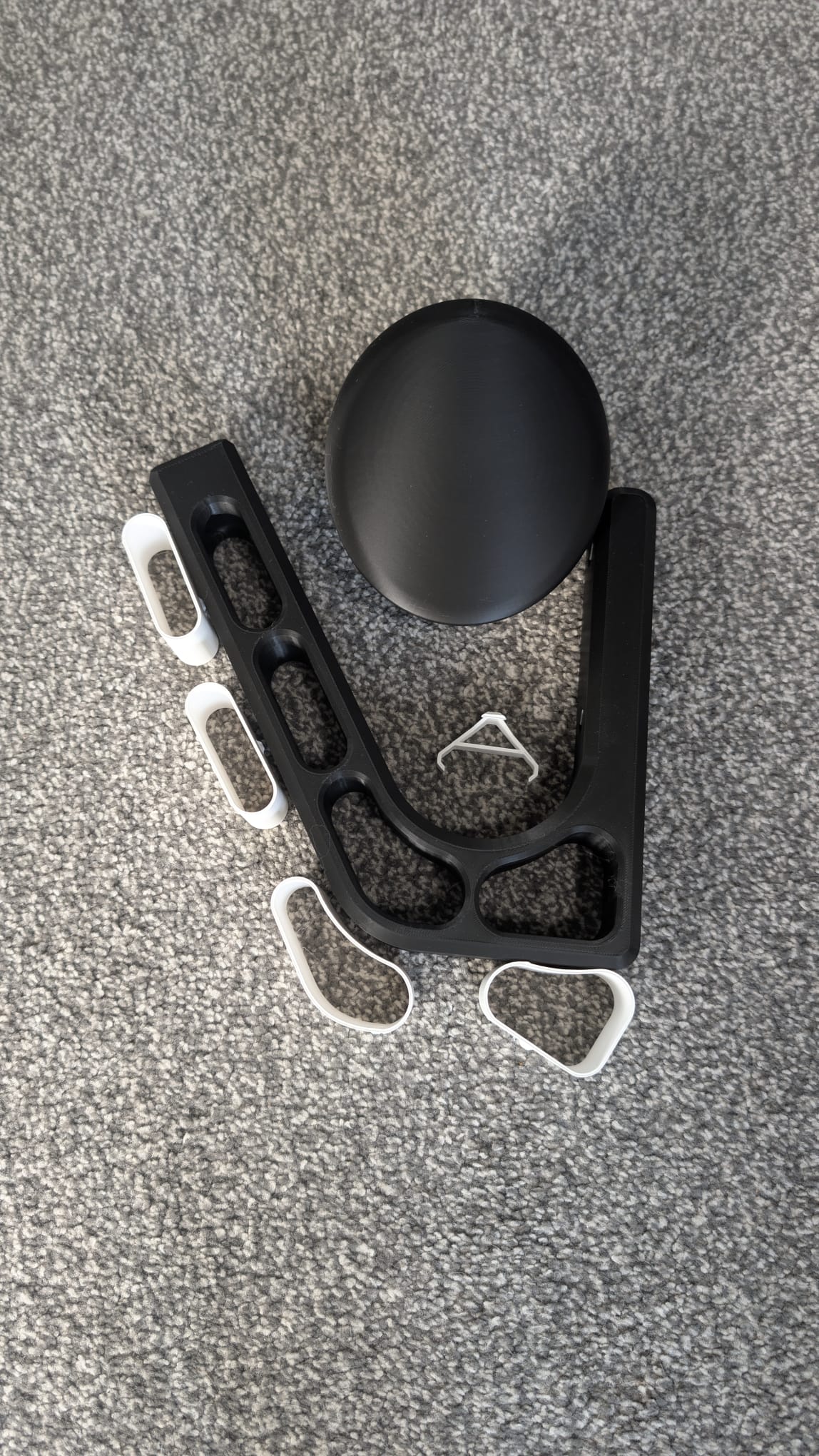 Motorcycle helmet and keys hanging from a wall-mounted helmet hanger